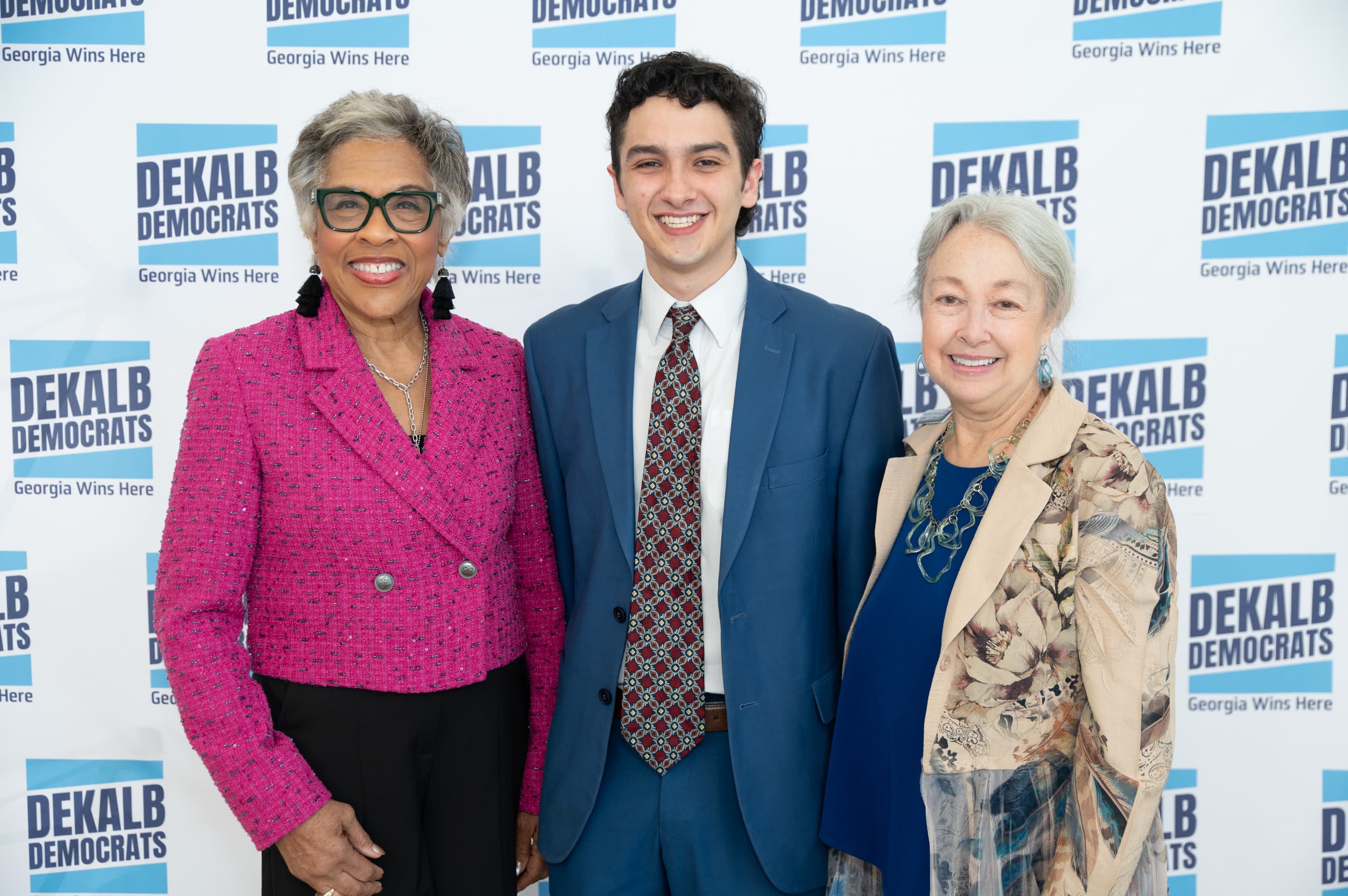 Guests posing at step-and-repeat at Blue Ballot Reception gala