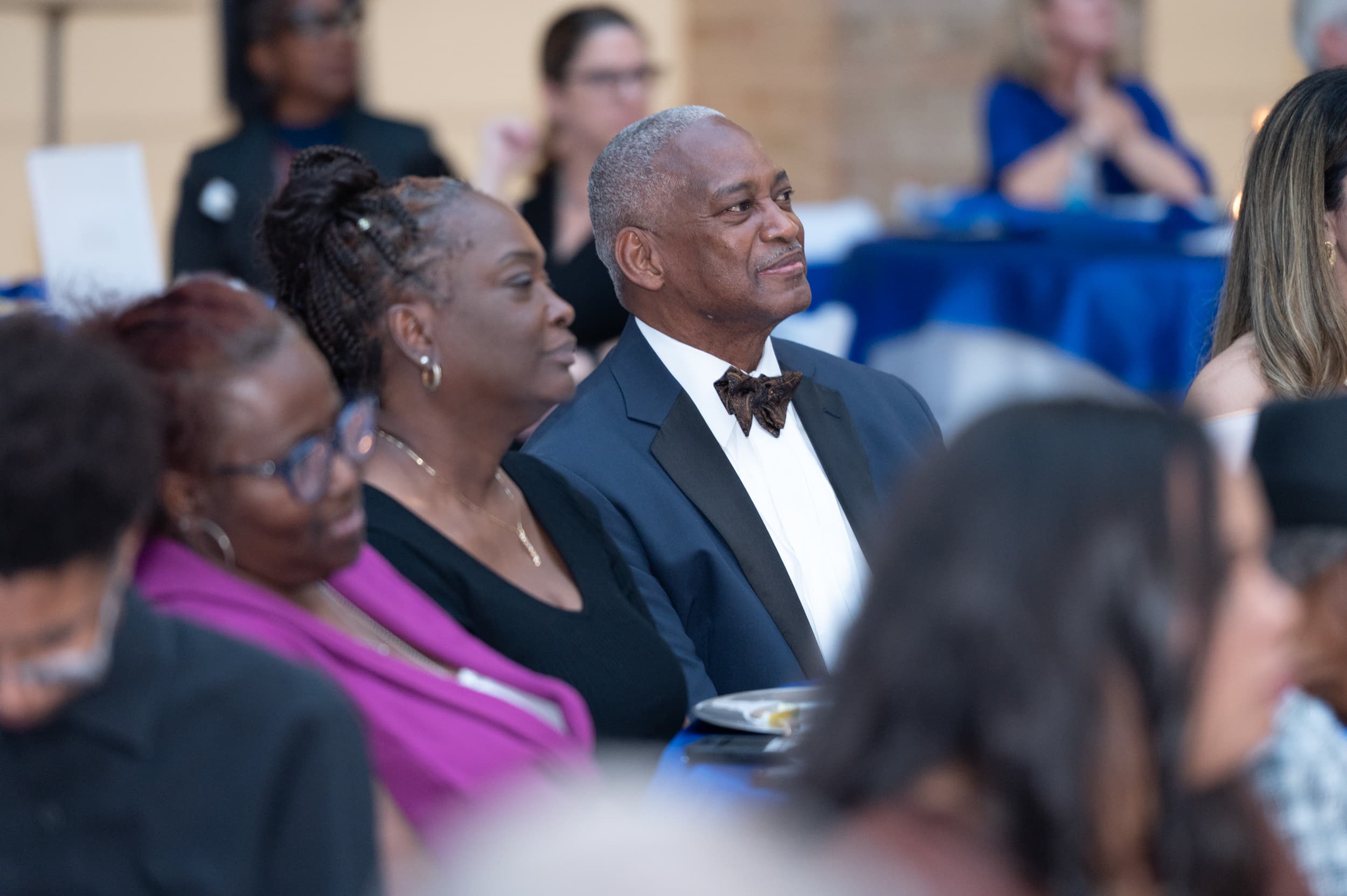 Formal guest in bow tie listening to speaker at Blue Ballot Reception gala dinner