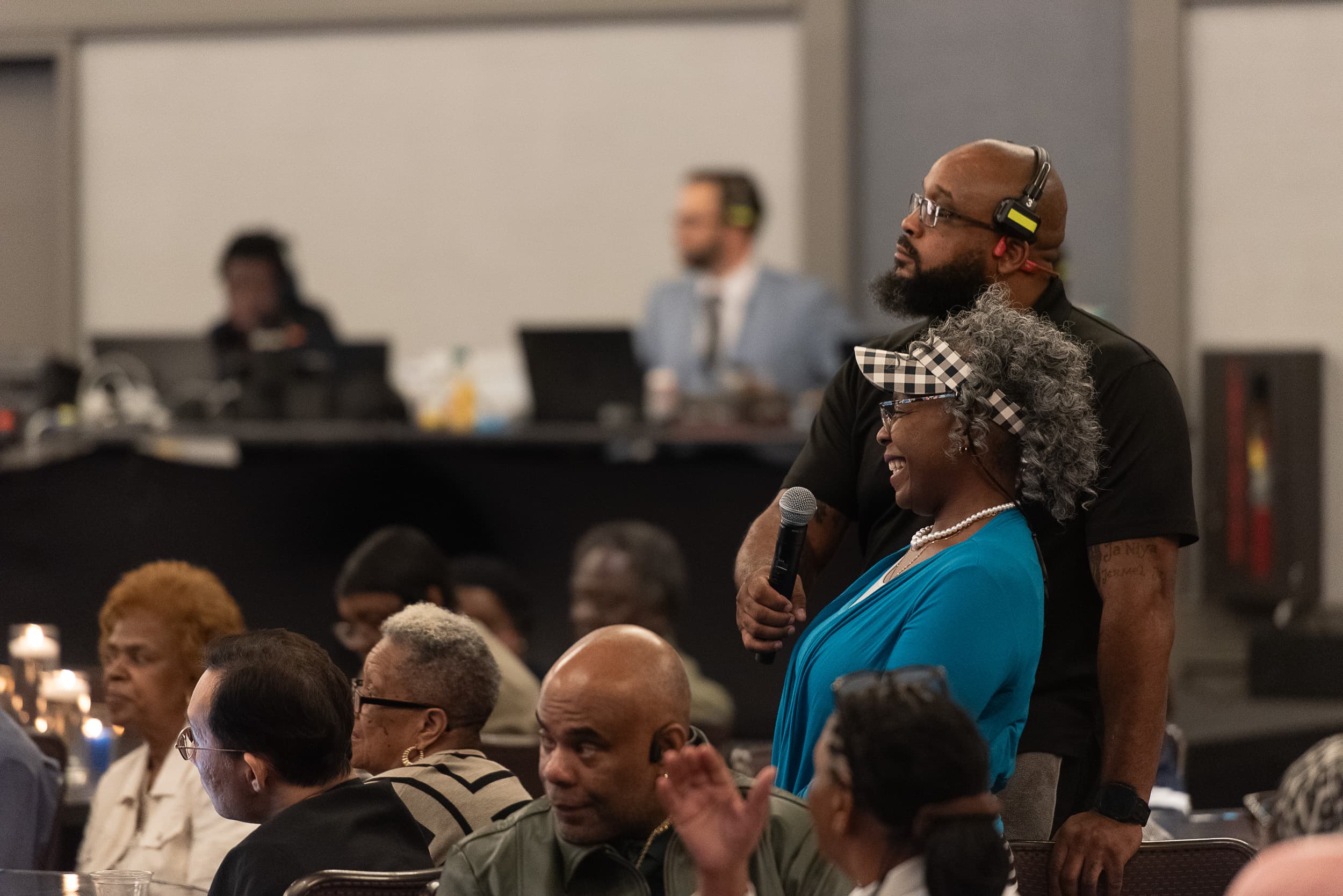 Audience member asking a question with microphone at AJC Live conference in Atlanta