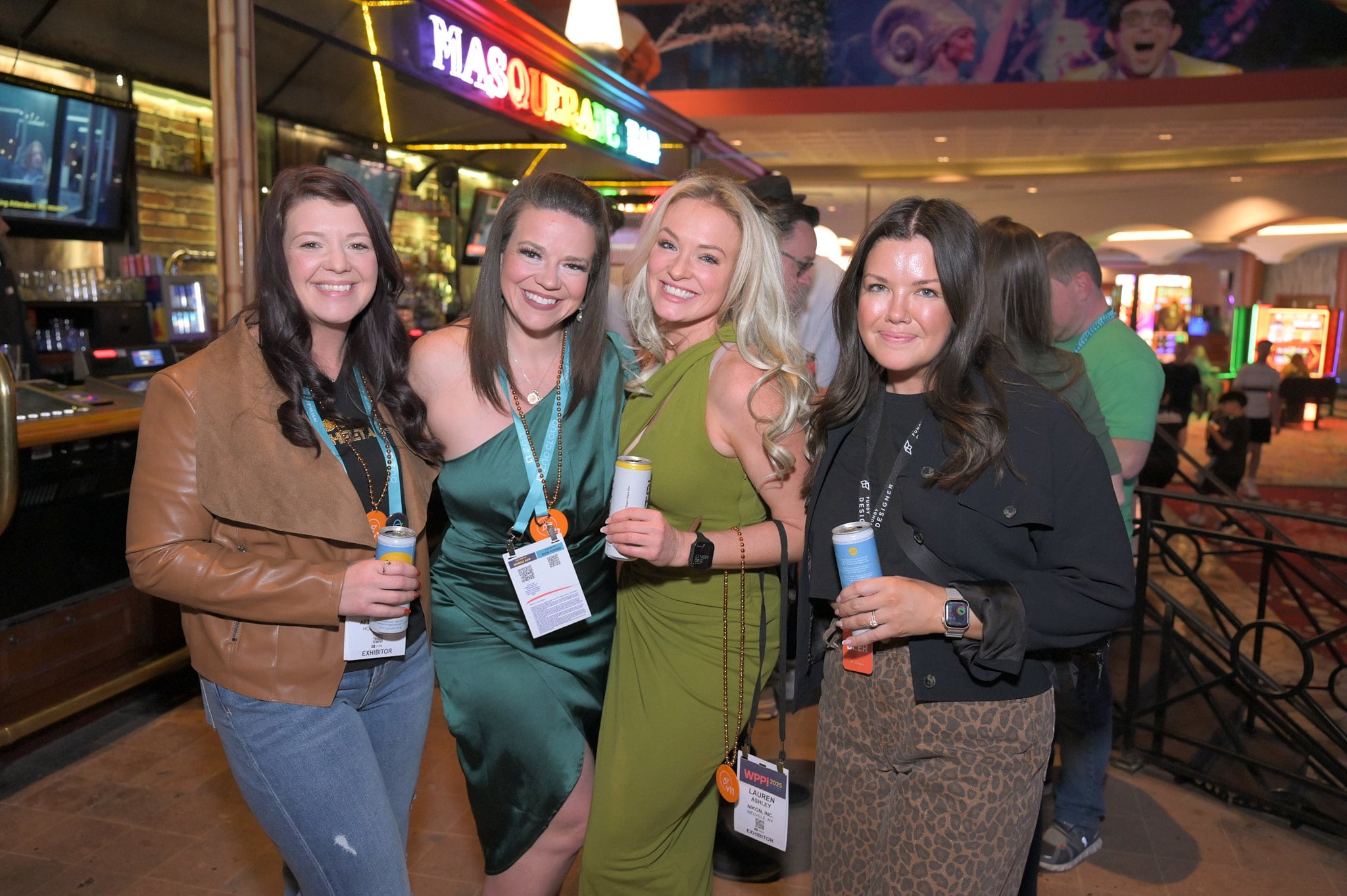 Trade show attendees with conference lanyards posing together at a polished evening reception, an image built for sponsor recap decks and next year's marketing