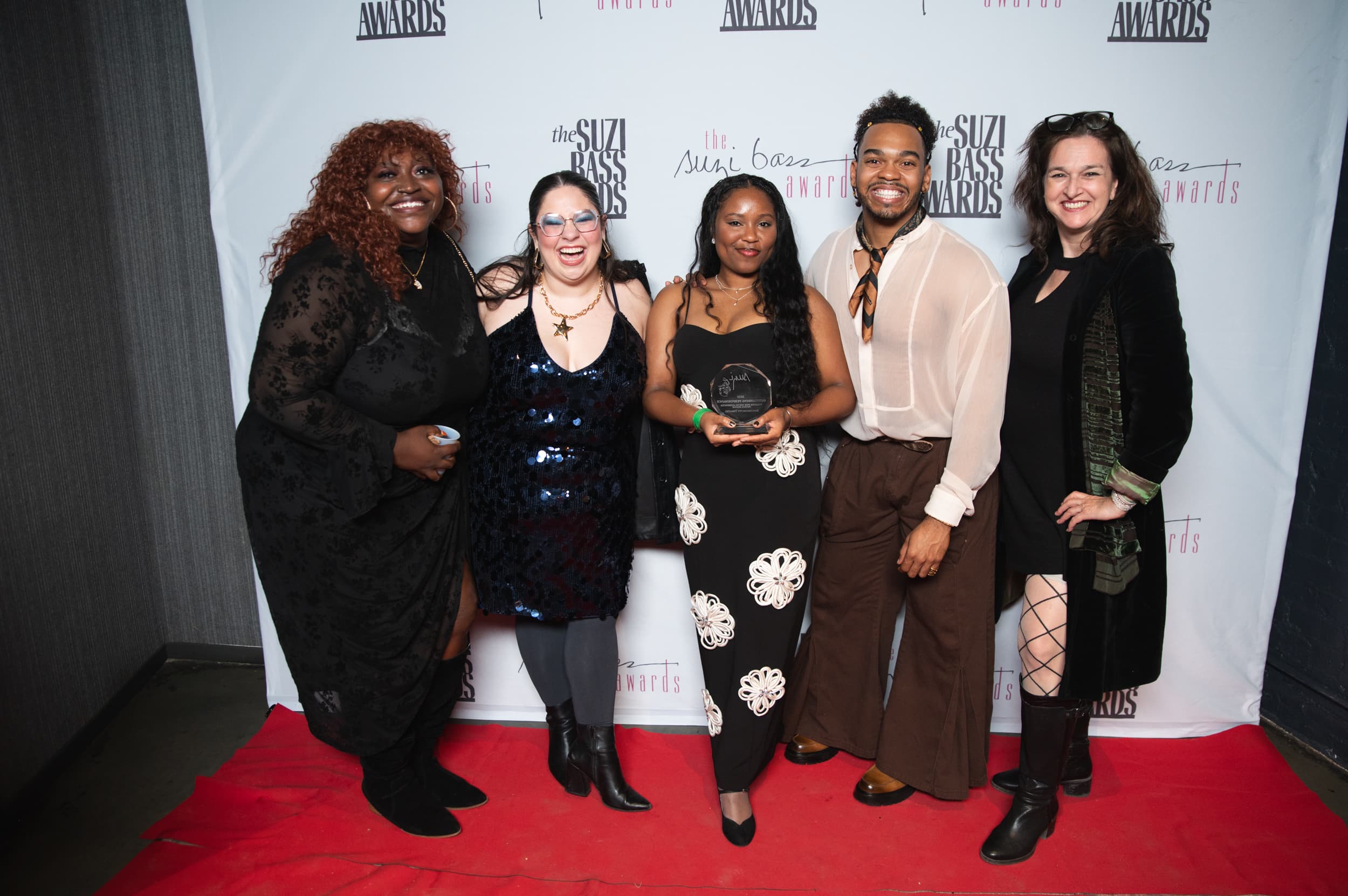 Award winners celebrating with trophy on red carpet at the Suzi Bass Awards in Atlanta