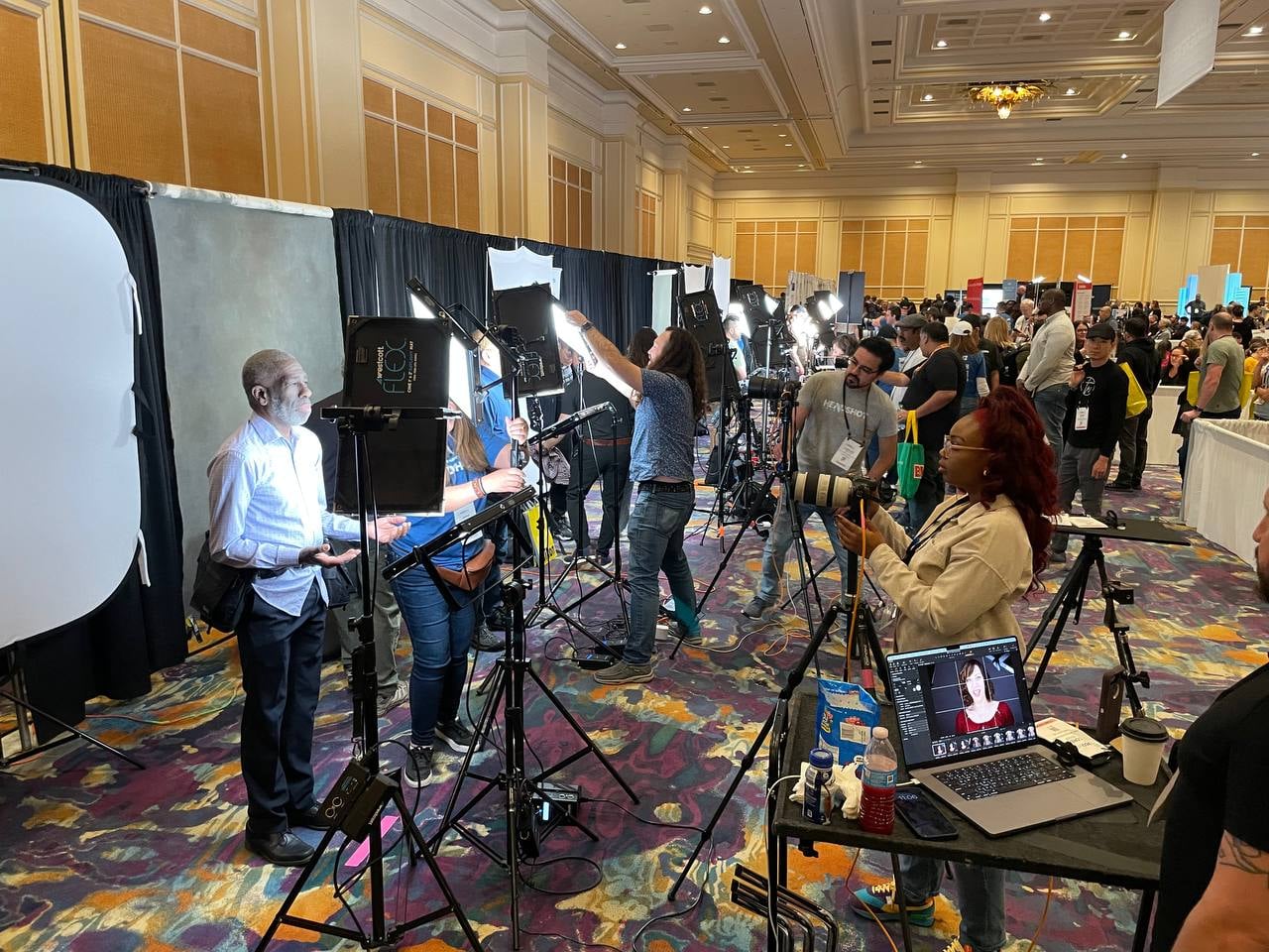 Professional headshot booth activation in action at a conference with multiple attendees being photographed