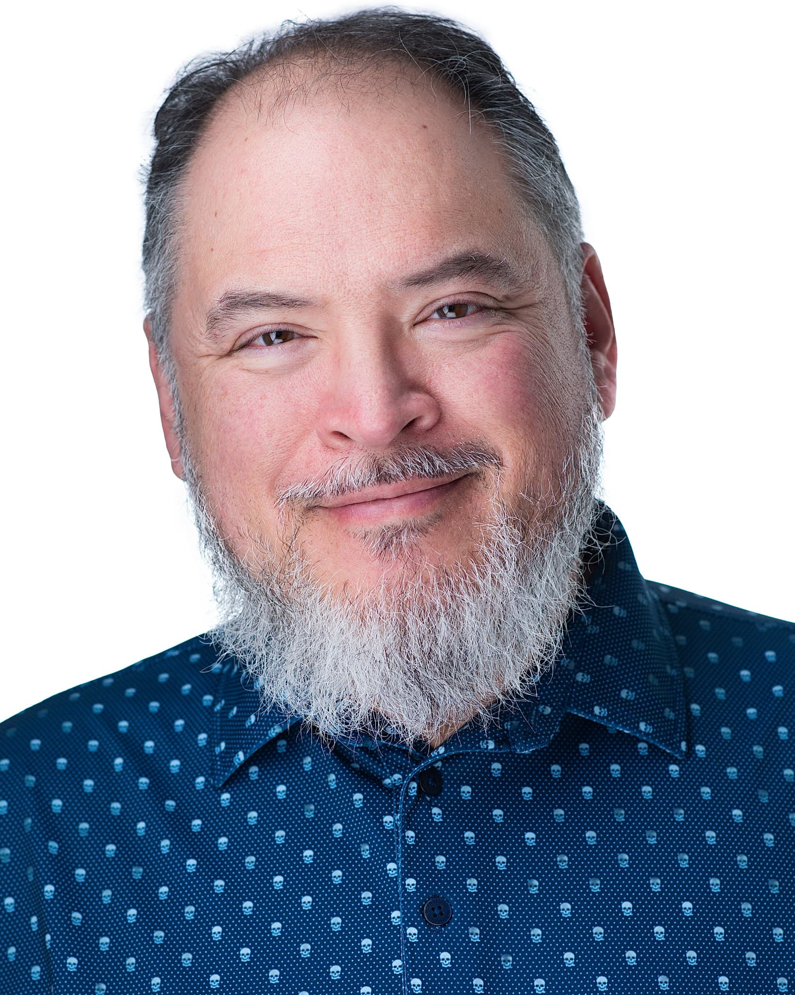 Atlanta commercial actor headshot of Frank Butler, man with a full gray beard and a friendly smile in a blue patterned shirt against a white background