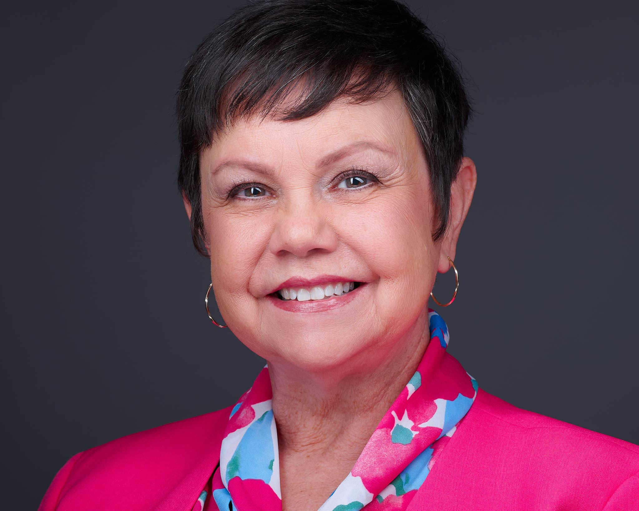 Professional business headshot of woman in pink blazer photographed in Atlanta studio