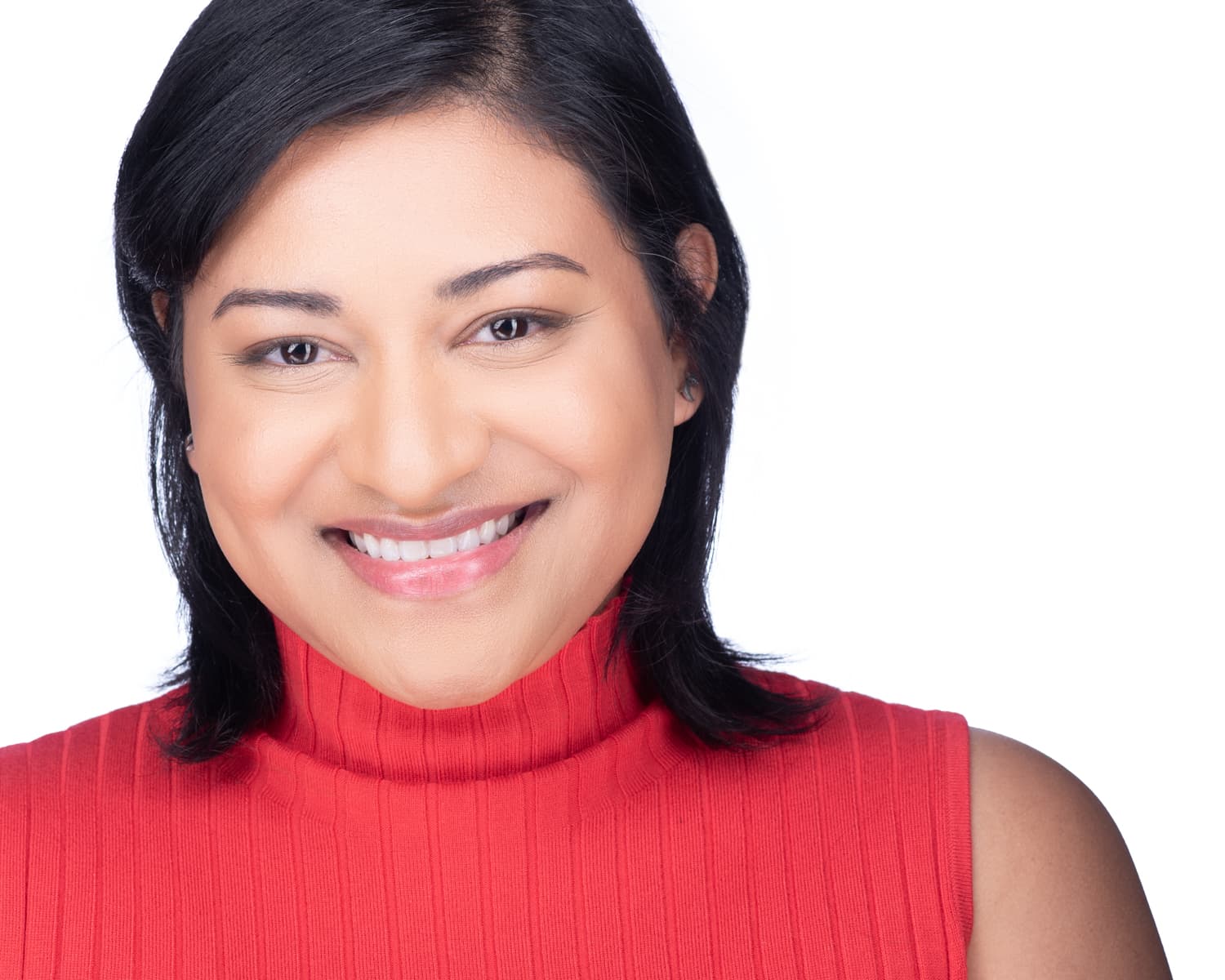 Female medical student ERAS headshot with genuine smile in bright red top, white background